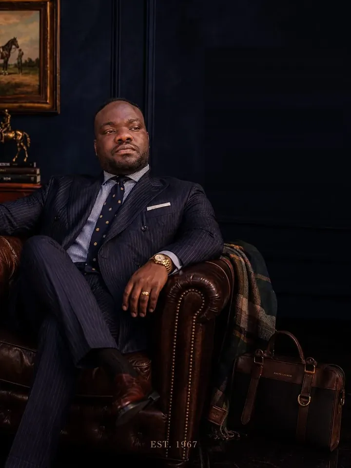 Collins Asein in a navy pinstripe suit