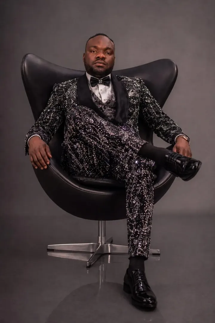 Collins Asein in a black sequined suit